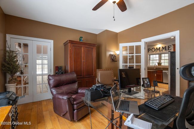 Formal Dining room, currently used as home office, featuring glass paneled french doors leading to kitchen and foyer | Image 13