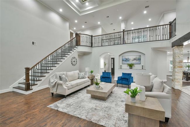 From the back entry overlooking your living room, a glimpse of your kitchen and the beautiful railing leading to your second level. | Image 4