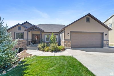 Craftsman-style home with a garage and a front yard | Image 1