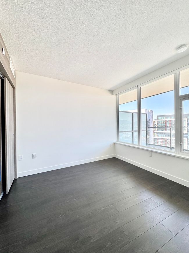 Empty room with baseboards, a textured ceiling, and dark wood-style flooring | Image 9