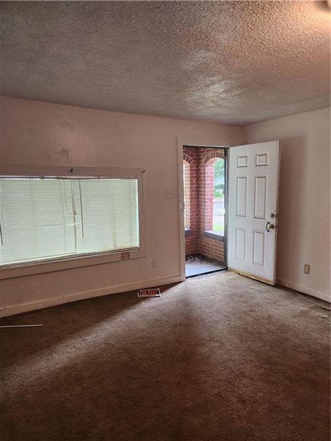 Carpeted empty room featuring a textured ceiling | Image 11