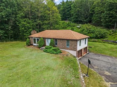 View of front of home featuring a garage and a front yard | Image 2