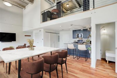 From this angle, you can appreciate the layout's versatility. To the right, a small room perfect for a twin bed or as an office space adds practicality to the living area. Natural light floods the space, highlighting its various textures and creating a warm, inviting ambiance. This photo is virtually staged. | Image 3