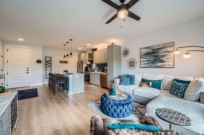 Living area featuring a ceiling fan, light wood-style flooring, and recessed lighting | Image 4