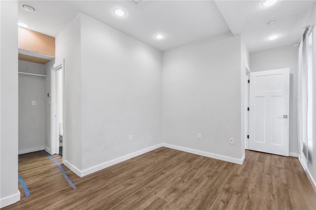 Unfurnished bedroom with wood finished floors and recessed lighting | Image 29