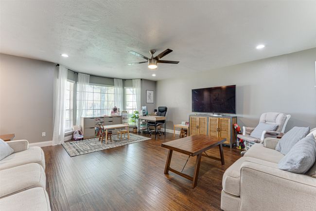 Living room featuring ceiling fan, recessed lighting, baseboards, and dark wood finished floors | Image 4
