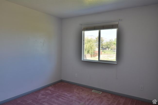 Carpeted spare room with baseboards | Image 32