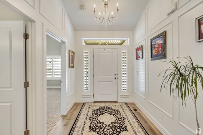 Entryway with light wood-style floors and a notable chandelier | Image 4