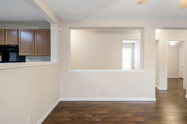 Spare room featuring a ceiling fan and dark wood-type flooring | Image 9