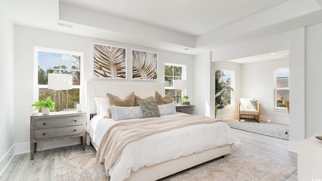 Bedroom with wood finished floors, baseboards, and a raised ceiling | Image 16