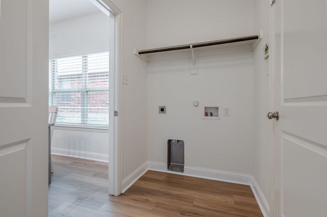 Laundry room with gas dryer hookup, light wood-type flooring, hookup for an electric dryer, and hookup for a washing machine | Image 24