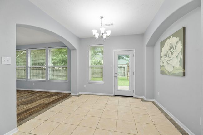 The breakfast nook sits just off the kitchen with backyard access and a wall of windows that bring in soft, natural light. | Image 15