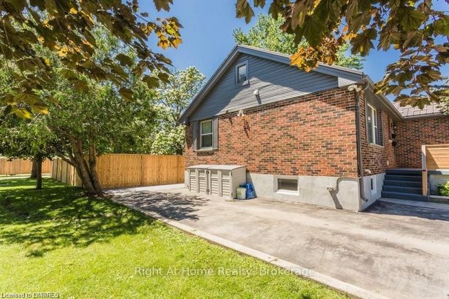 side of house with covered garbage area | Image 18