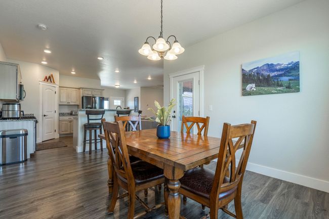 Dining room with a chandelier, dark wood-style floors, healthy amount of natural light, and recessed lighting | Image 11
