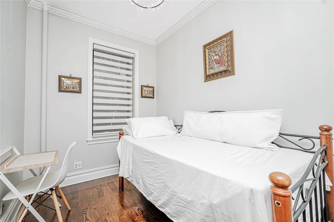 Bedroom featuring crown molding and wood finished floors | Image 25