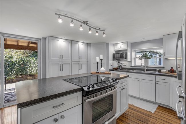White custom cabinetry & SS appliances. | Image 5