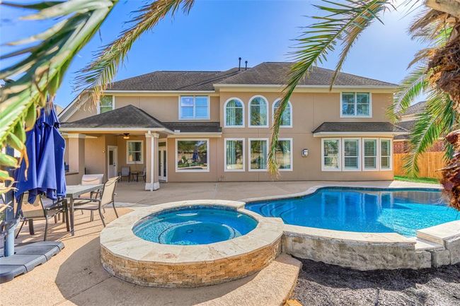 Elegant stacked stone enhances the allure of the raised spa. | Image 33