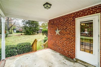 Covered side porch with exposed brick | Image 3