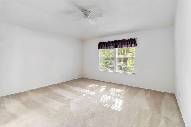 Unfurnished room with a ceiling fan, carpet, and baseboards | Image 20