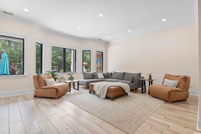 Living area with recessed lighting, baseboards, light wood-type flooring, and ornamental molding | Image 5