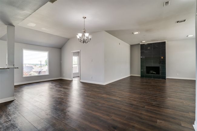 Front living room view. The door on the right is the 4th bedroom or multi purpose room is large and has wood floors split from the others | Image 4