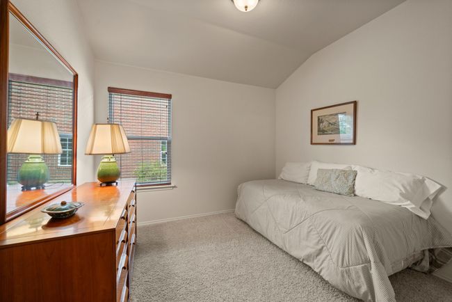 Alternate angle of the guest bedroom showcasing built-in bookshelves, ideal for a home library or study nook. | Image 29