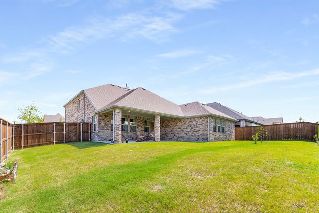 Back of property featuring a fenced backyard, brick siding, and roof with shingles | Image 37