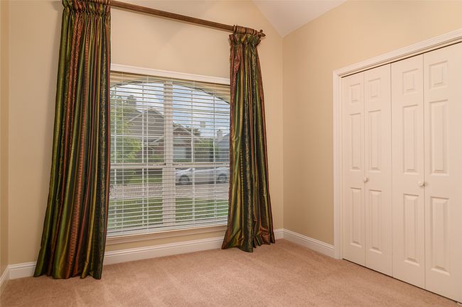 Unfurnished bedroom featuring carpet floors, vaulted ceiling, a closet, and baseboards | Image 15