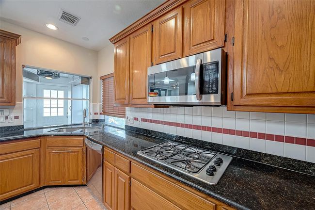 Another view of Kitchen with Microwave and Gas Cooking. | Image 11