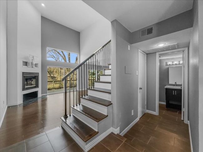 Stairs, a towering ceiling, and hardwood / wood-style floors | Image 10