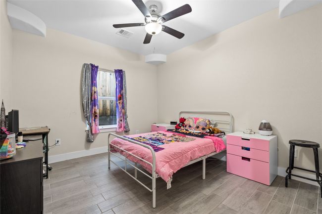 Bedroom featuring light wood-type flooring and ceiling fan | Image 25