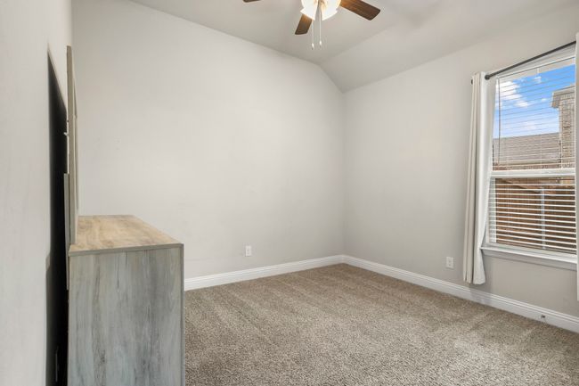 Unfurnished room featuring ceiling fan, carpet, and vaulted ceiling | Image 16