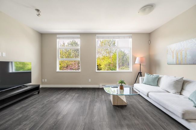 Living area with dark wood-style floors and baseboards | Image 5