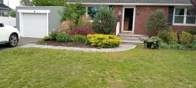 View of front of house featuring brick siding, a garage, a front lawn, a shingled roof, and asphalt driveway | Image 6