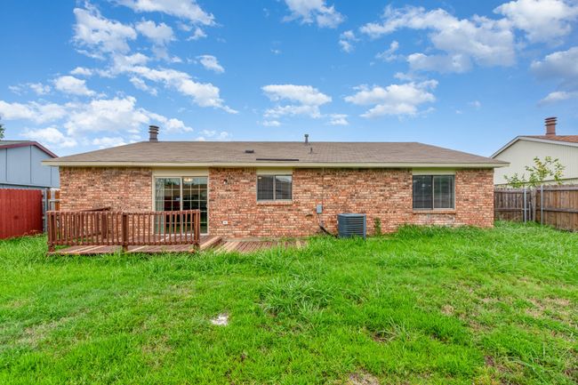 Rear view of house with brick siding and a deck | Image 22