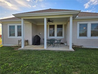 Rear view of house with a lawn, ceiling fan, and a patio | Image 3