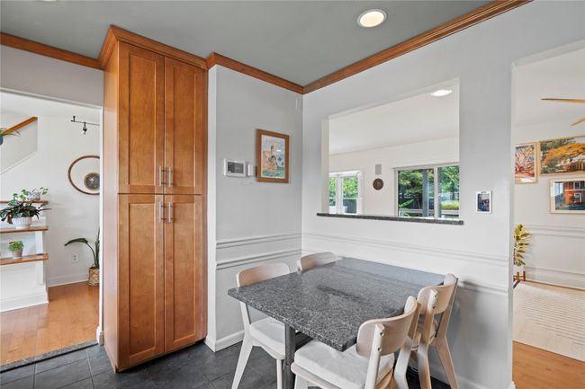 Kitchen with stainless steel appliances, backsplash, open shelves, dark stone countertops, and recessed lighting | Image 16