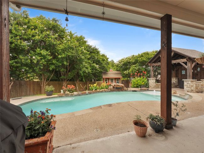 View of pool featuring a gazebo, a fenced backyard, an outbuilding, and a patio | Image 20