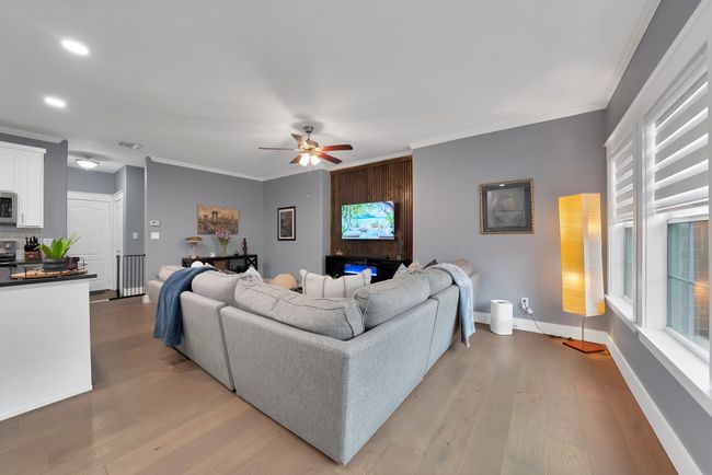 Living area featuring ceiling fan, light wood-style flooring, crown molding, baseboards, and recessed lighting | Image 20