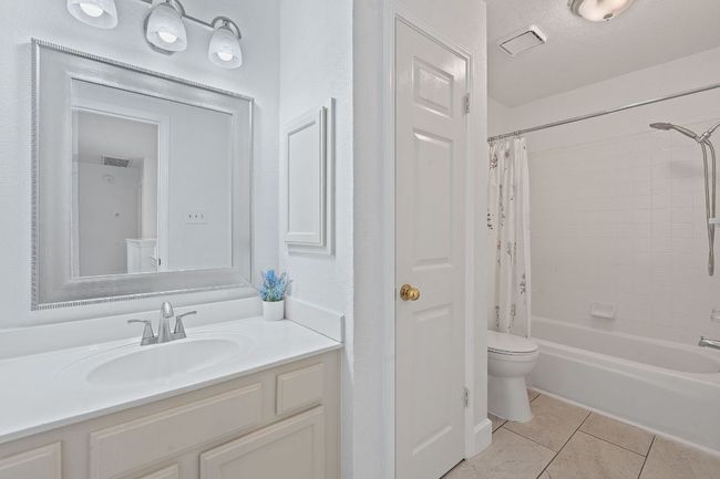 Full bath featuring vanity, tile patterned floors, and shower / tub combo | Image 24