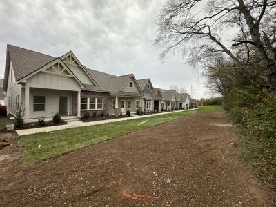 Unit 205 under construction - exterior w/ wooded tree line. | Image 2