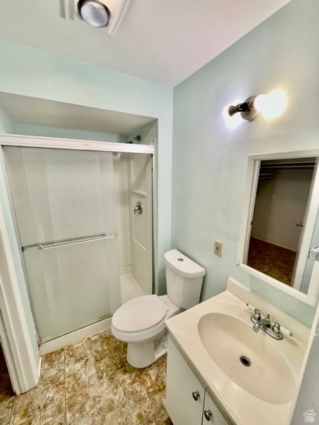 Bathroom featuring toilet, a shower stall, and vanity | Image 14