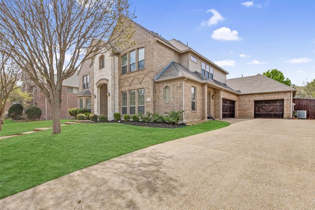 This custom home is located on .27 acres and features 3 garage spaces. (grass has been digitally enhanced). | Image 38