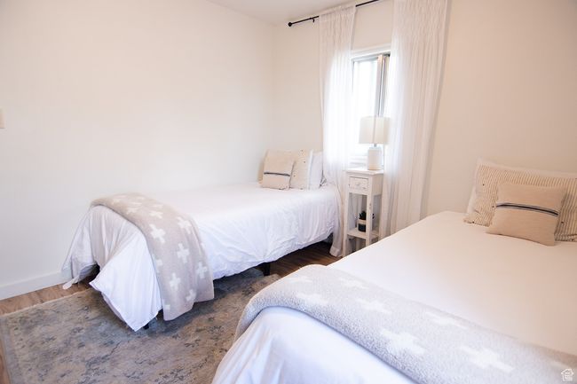 Bedroom with wood finished floors and baseboards | Image 24