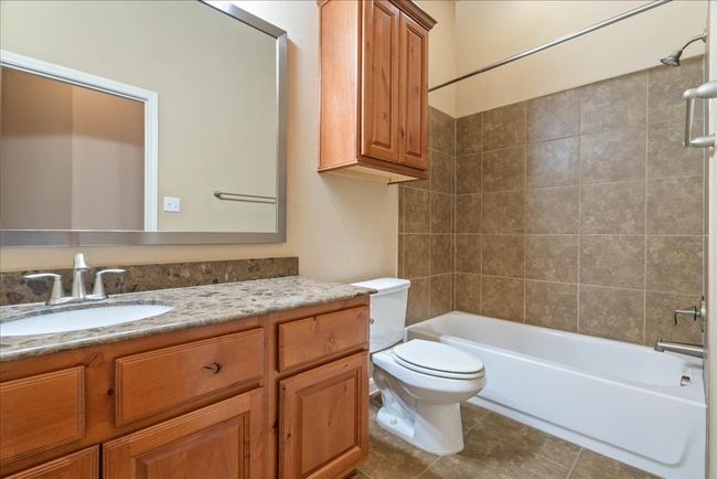 The secondary bathroom has a vanity and shower/tub combination. | Image 29