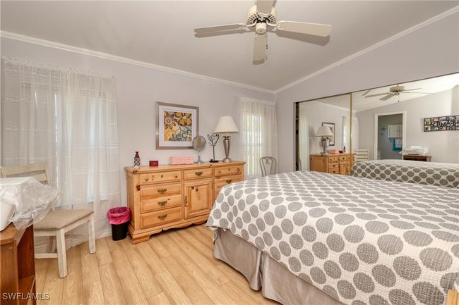 Bedroom featuring ceiling fan, light hardwood / wood-style flooring, lofted ceiling, a closet, and ornamental molding | Image 15