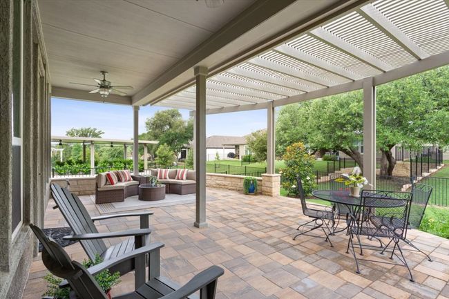 View of patio featuring covered patio space + pergola, a large outdoor living space, and ceiling fans | Image 32