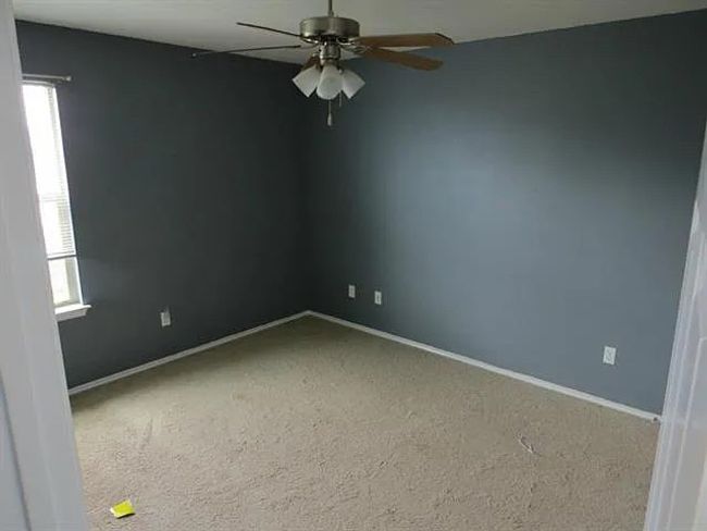 Unfurnished room featuring healthy amount of natural light, ceiling fan, and carpet flooring | Image 5