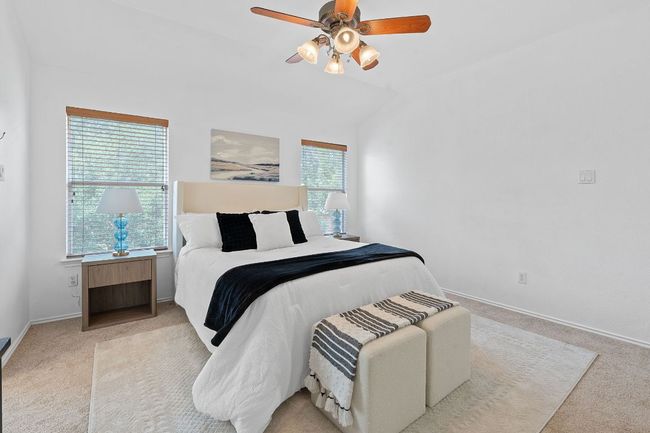Bedroom with carpet floors, lofted ceiling, baseboards, and a ceiling fan | Image 18