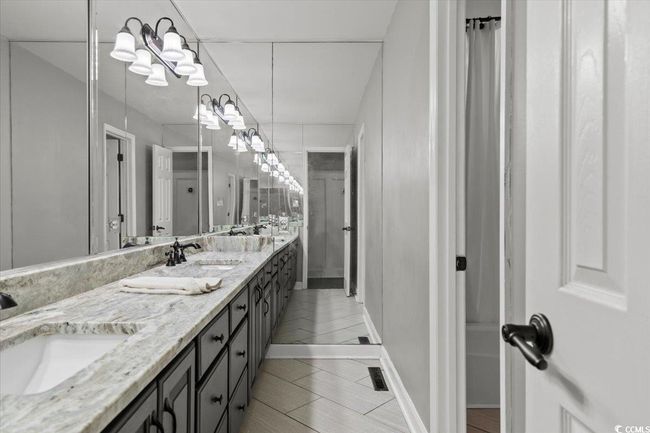 Full bath with double vanity and tile patterned flooring | Image 26